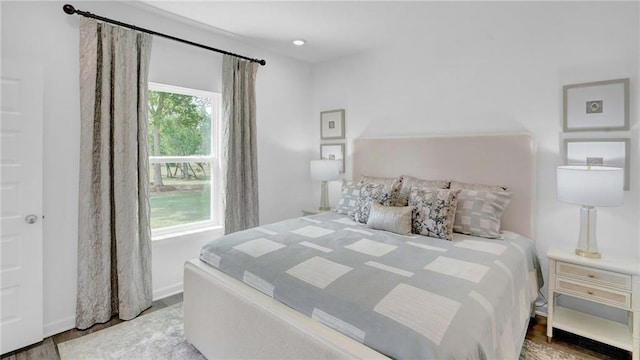 bedroom with wood finished floors and baseboards