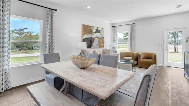 dining area featuring wood finished floors, baseboards, and recessed lighting