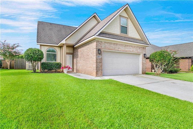 view of front of property with a garage and a front lawn