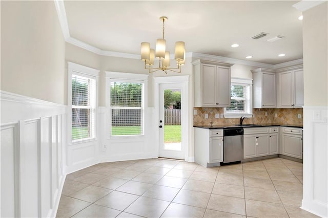 kitchen featuring crown molding, stainless steel dishwasher, a wealth of natural light, and light tile patterned floors