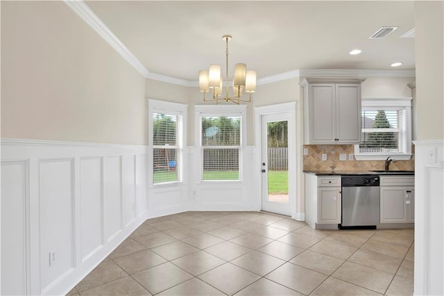 kitchen with light tile patterned flooring, a healthy amount of sunlight, stainless steel dishwasher, and decorative backsplash