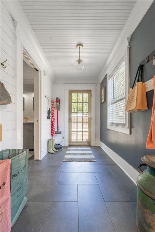 doorway to outside featuring dark tile patterned floors