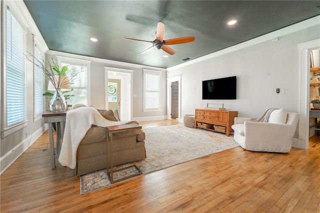 living room with light hardwood / wood-style floors and ceiling fan