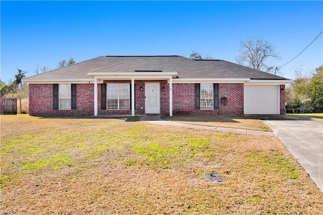 ranch-style house with a garage and a front lawn