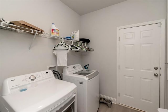 12927 Sanderling Loop, Daphne, AL 36527 - laundry room with washing machine and clothes dryer and light wood-style floors