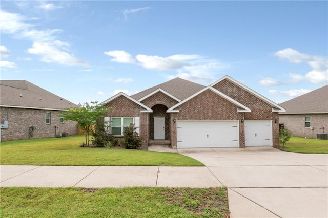 12927 Sanderling Loop, Daphne, AL 36527 - view of front facade with brick siding, concrete driveway, a garage, and a front yard