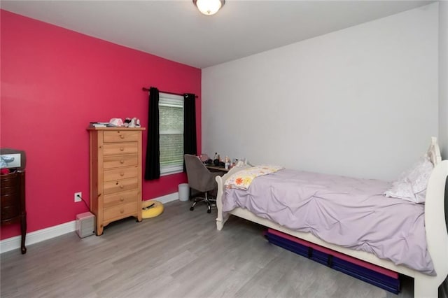 12927 Sanderling Loop, Daphne, AL 36527 - bedroom featuring wood finished floors and an accent wall