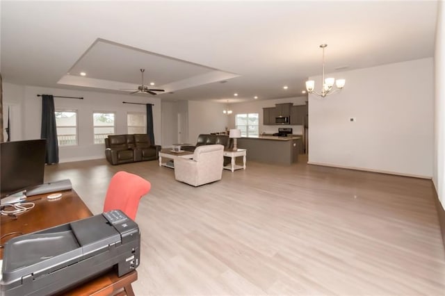 12927 Sanderling Loop, Daphne, AL 36527 - living area featuring a chandelier, a tray ceiling, ceiling fan, recessed lighting, and light wood-style floors