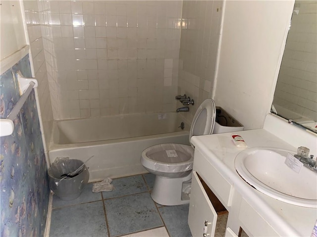 full bathroom with tiled shower / bath, vanity, toilet, and tile patterned floors