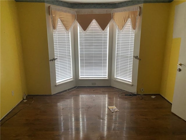 empty room with dark hardwood / wood-style flooring