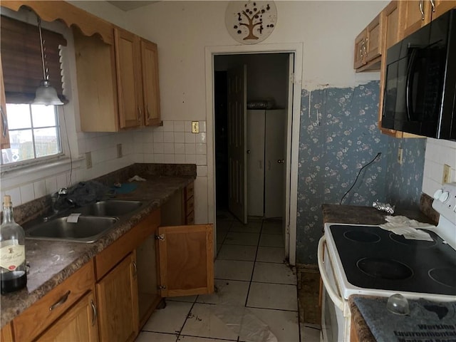 kitchen with electric stove, sink, hanging light fixtures, light tile patterned flooring, and decorative backsplash