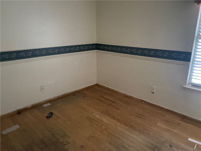 unfurnished room with hardwood / wood-style floors