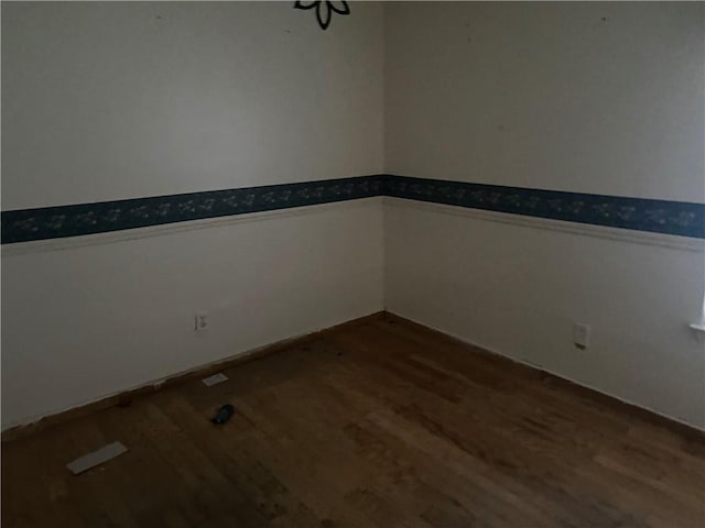 unfurnished room featuring hardwood / wood-style flooring