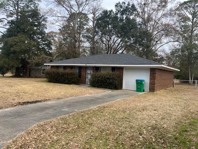 single story home featuring a garage and a front yard