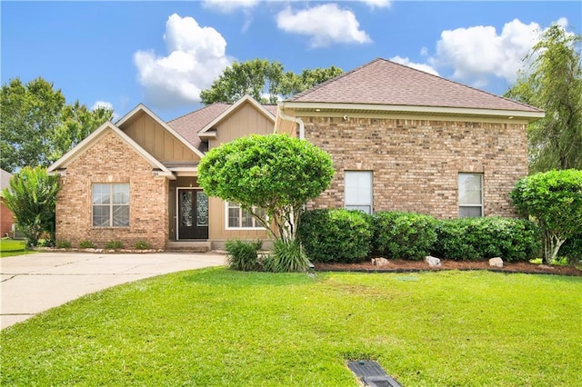 3245 Mcrae Dr, Mobile, AL 36695 - view of front of property with board and batten siding, a front yard, and brick siding