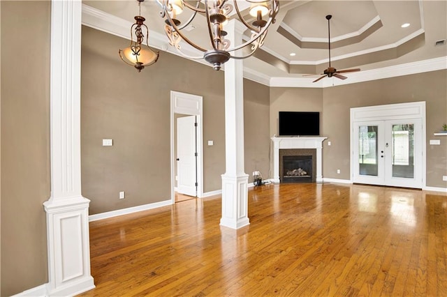3245 Mcrae Dr, Mobile, AL 36695 - unfurnished living room with ornate columns, ceiling fan, crown molding, a glass covered fireplace, and light wood finished floors
