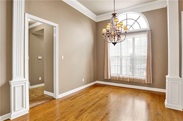 3245 Mcrae Dr, Mobile, AL 36695 - unfurnished room featuring a chandelier, wood finished floors, ornamental molding, and ornate columns