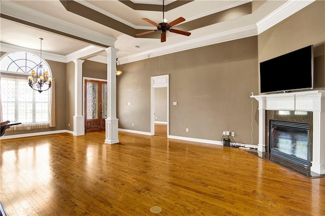 3245 Mcrae Dr, Mobile, AL 36695 - unfurnished living room featuring decorative columns, ornamental molding, wood finished floors, ceiling fan, and a fireplace