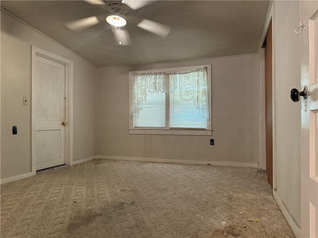 spare room with light colored carpet and ceiling fan