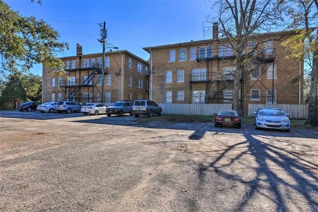 view of apartment building / complex featuring uncovered parking