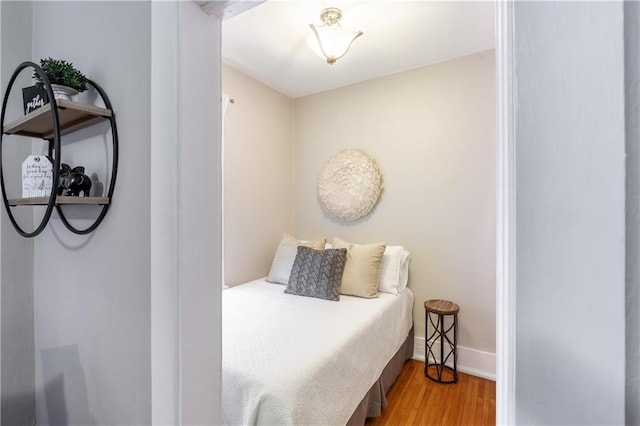 bedroom with light wood-style floors and baseboards