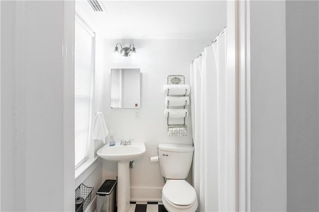 bathroom with toilet and a sink
