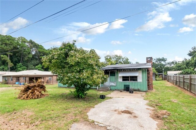 back of property featuring a lawn