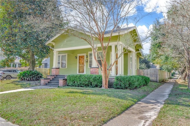 bungalow-style home with a front yard