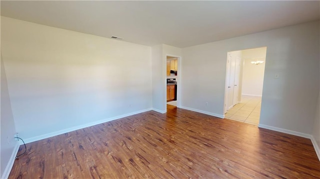 unfurnished room with light hardwood / wood-style floors