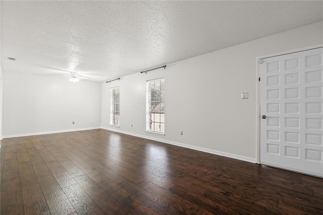 unfurnished room featuring ceiling fan, dark hardwood / wood-style flooring, and a textured ceiling