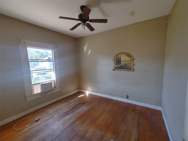 spare room featuring cooling unit, hardwood / wood-style floors, and ceiling fan