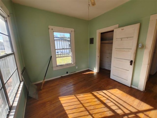 unfurnished bedroom with dark hardwood / wood-style floors