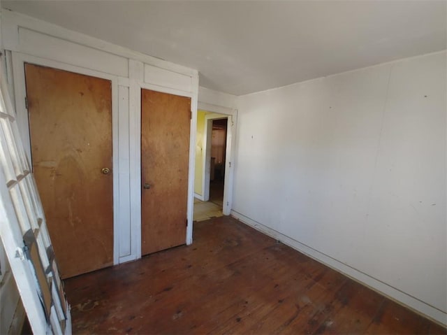 unfurnished bedroom featuring dark wood-type flooring