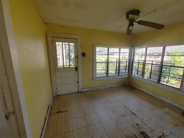 interior space with ceiling fan