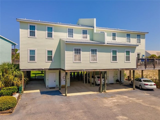 50 Forney Johnston Dr Unit 8B, Dauphin Island, AL 36528 - view of front facade with a carport, driveway, and metal roof