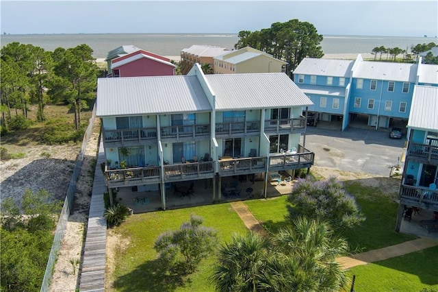 50 Forney Johnston Dr Unit 8B, Dauphin Island, AL 36528 - back of house with metal roof, a water view, and a lawn
