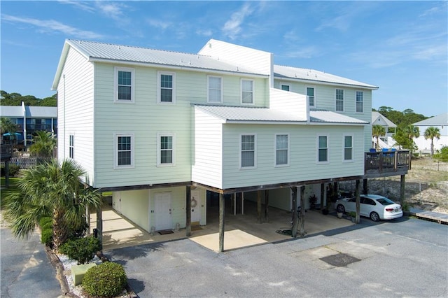 50 Forney Johnston Dr Unit 8B, Dauphin Island, AL 36528 - back of property featuring a carport, metal roof, and driveway