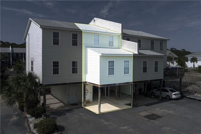 50 Forney Johnston Dr Unit 8B, Dauphin Island, AL 36528 - rear view of property with a carport, metal roof, and driveway