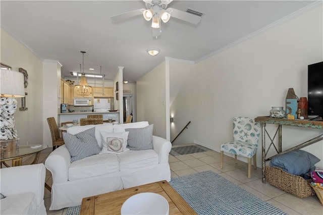 50 Forney Johnston Dr Unit 8B, Dauphin Island, AL 36528 - living room featuring crown molding, light tile patterned floors, a ceiling fan, baseboards, and a chandelier