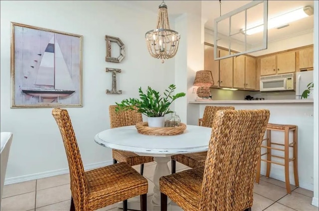 50 Forney Johnston Dr Unit 8B, Dauphin Island, AL 36528 - dining area with light tile patterned floors, a chandelier, and baseboards