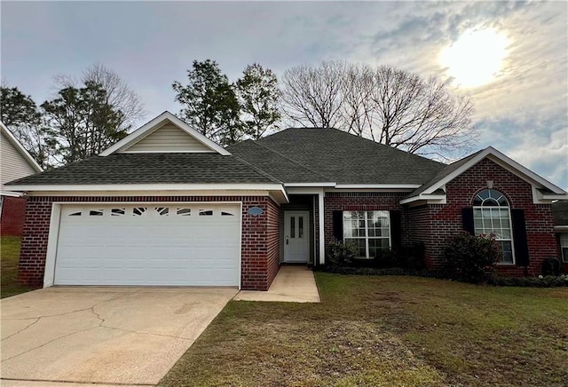 ranch-style home with a garage, driveway, brick siding, roof with shingles, and a front yard