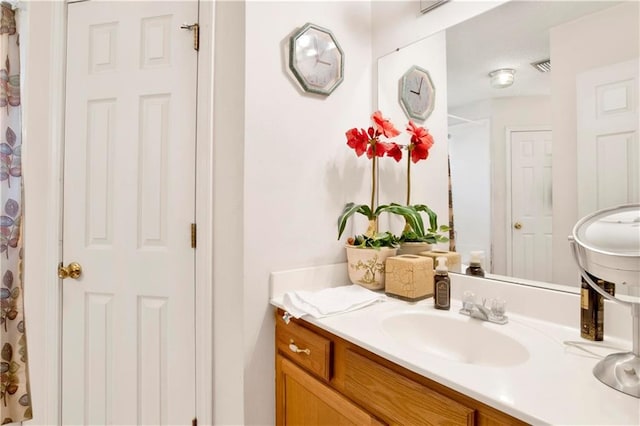 bathroom with visible vents, a shower with curtain, and vanity