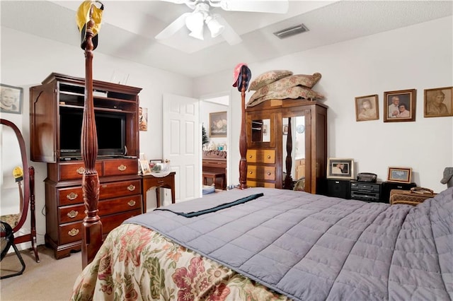 carpeted bedroom with visible vents and a ceiling fan