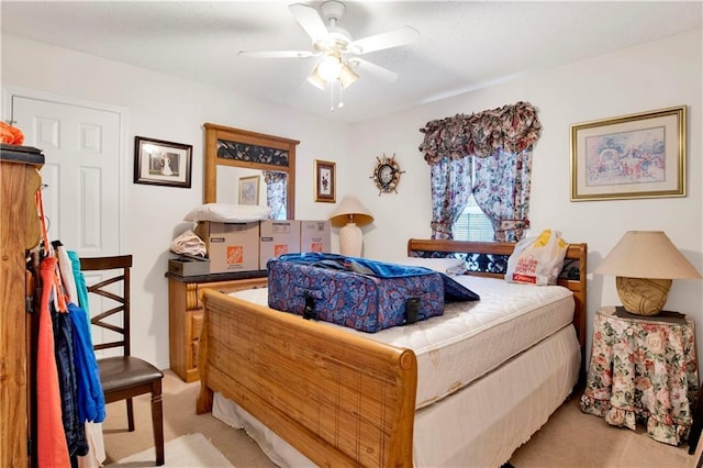 bedroom with light colored carpet and a ceiling fan