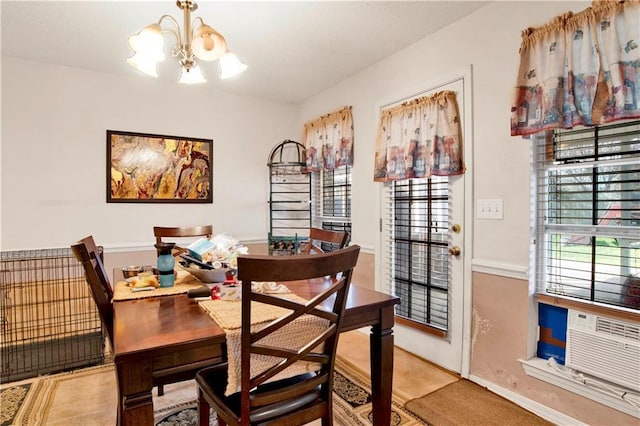 dining space featuring cooling unit and a chandelier