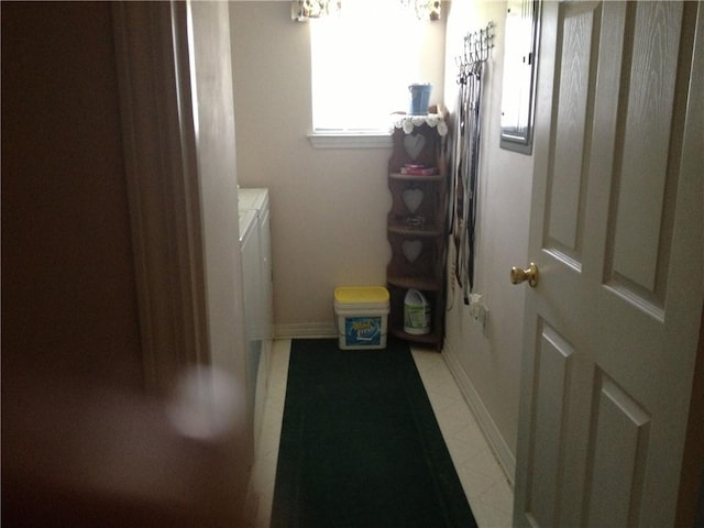 laundry room featuring laundry area, baseboards, and separate washer and dryer