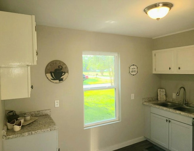 165 Stephens St, Mobile, AL 36606 - kitchen with a sink, plenty of natural light, light countertops, and white cabinets