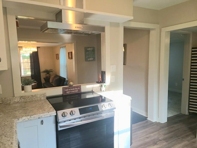 165 Stephens St, Mobile, AL 36606 - kitchen featuring stainless steel electric range oven, wall chimney exhaust hood, wood finished floors, a chandelier, and baseboards