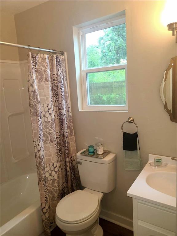 165 Stephens St, Mobile, AL 36606 - bathroom featuring toilet, vanity, and shower / bath combo with shower curtain