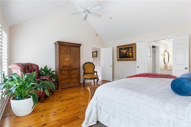 bedroom with light hardwood / wood-style floors, high vaulted ceiling, ceiling fan, and ensuite bathroom